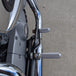 The TC Bros. Mid Controls Kit for 2004-2013 Harley-Davidson Sportster includes black brackets, silver foot pegs, bolts, nuts, washers, and a linkage rod from TC Bros., all arranged on a white background.