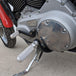 The TC Bros. Mid Controls Kit for 2004-2013 Harley-Davidson Sportster includes black brackets, silver foot pegs, bolts, nuts, washers, and a linkage rod from TC Bros., all arranged on a white background.