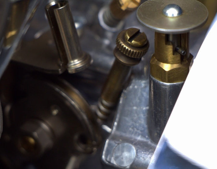 A close-up of an adjustable Pangor Cycles All Thumbs Idle Speed Screw For S&S Super E/G Carburetor - Antique Brass machine.