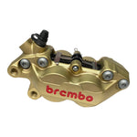 The Brembo P4 Axial Brake Caliper by Brembo features a gold four-piston design with red logo, visible bolts, and hydraulic fitting; it mounts axially and is shown in a side view.