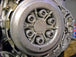 A picture of a clutch on a Yamaha XS650 car, featuring LC Fabrications XS650 Clutch Spring Retainer Set.
