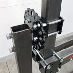 A DIY Frame Jig Rotisserie Stand by Chop Source is attached to a motorcycle frame jig while welding.