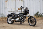 Two TC Bros. motorcycle brake rotors are shown: one is a 12.6" oversized rear floating rotor with a wavy edge for 2000-Up Harley-Davidson wheels, and the other has a smooth circular edge.