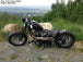A motorcycle with a Moto Iron® 2.4 Gal. Sportster Gas Tank Fits 1995-03 parked on top of a hill.
