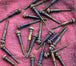 A group of Pangor Cycles All Thumbs Idle Speed Screws on a red cloth.
