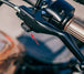 A close up of the Drag Specialties LED Handlebar Marker Lights 2004-21 Sportster - Chrome on a motorcycle.