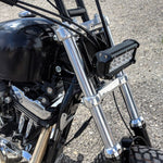 The TC Bros. Scrambler LED Headlight Kit for Harley-Davidson includes two black LED light bars with wiring, connectors, brackets, and hardware—perfect for off-road use or upgrading your Harley's lighting system.