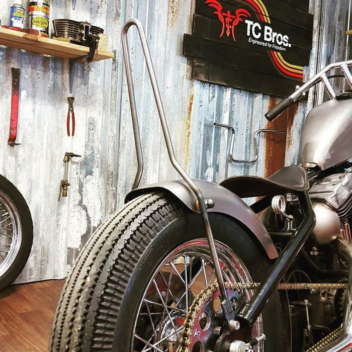 A TC Bros. Original DIY Sissy Bar Kit is parked in a garage.