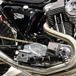 Two TC Bros. Pro Series Billet Sprocket/Pulley Cover kits for Harley-Davidson Sportster models (1986-2003) are shown—one in black and one in silver—with included screws, bolts, and spacers. The installed view highlights how the TC Bros. billet transmission pulley cover fits seamlessly onto a Sportster engine.