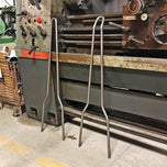 A TC Bros. Tall DIY Sissy Bar Kit is sitting next to a machine.