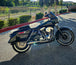 A motorcycle exhaust pipe with an American flag and a SP Concepts Lane Splitter Exhaust Twin Cam Touring 95-16 (stainless) on it.