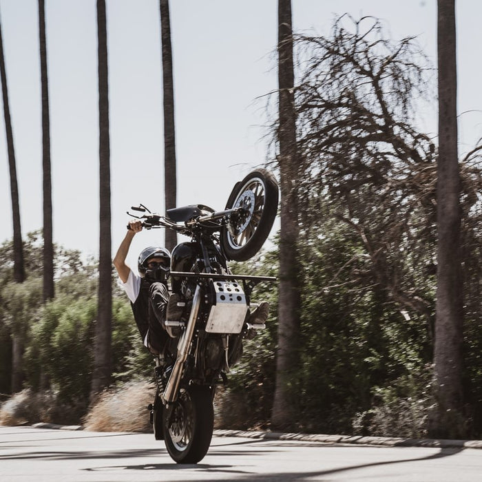 A man doing a handstand on a TC Bros. Dyna Skid Plate 1991-2017 Models - Black.