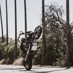 A man doing a handstand on a TC Bros. Dyna Skid Plate 1991-2017 Models - Black.