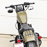 Two TC Bros. 1" Window Handlebars, one chrome and one black, featuring a distinctive rectangular center design inspired by TC Bros. Harley-Davidson styles, are displayed on a white background.