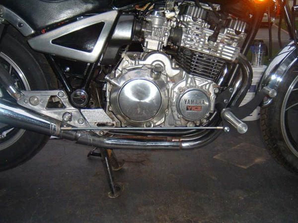 A picture of a TC Bros. Yamaha Maxim XJ750 Forward Controls Kit motorcycle engine parked in a garage.